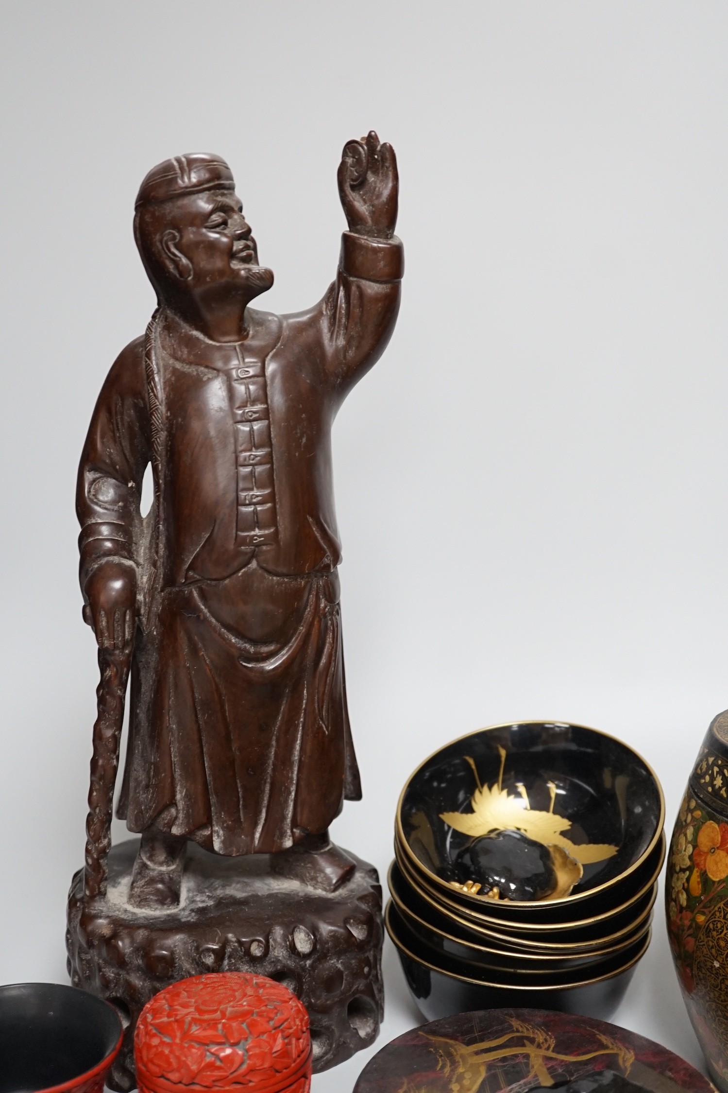 A Japanese red lacquer natsume, 7cm high, and matching tea cup Together with Mixed decorative Oriental and Indian lacquer wares and, a Chinese carved hardwood figure of a sage 39.5cm